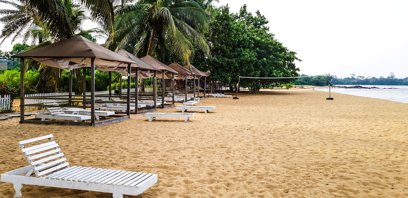 Beach umbrellas along the shore at Kribi, Cameroon